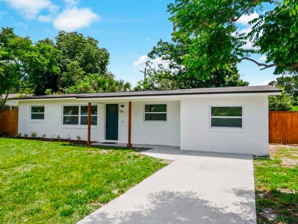 After: repainted ranch house with tidy landscaping